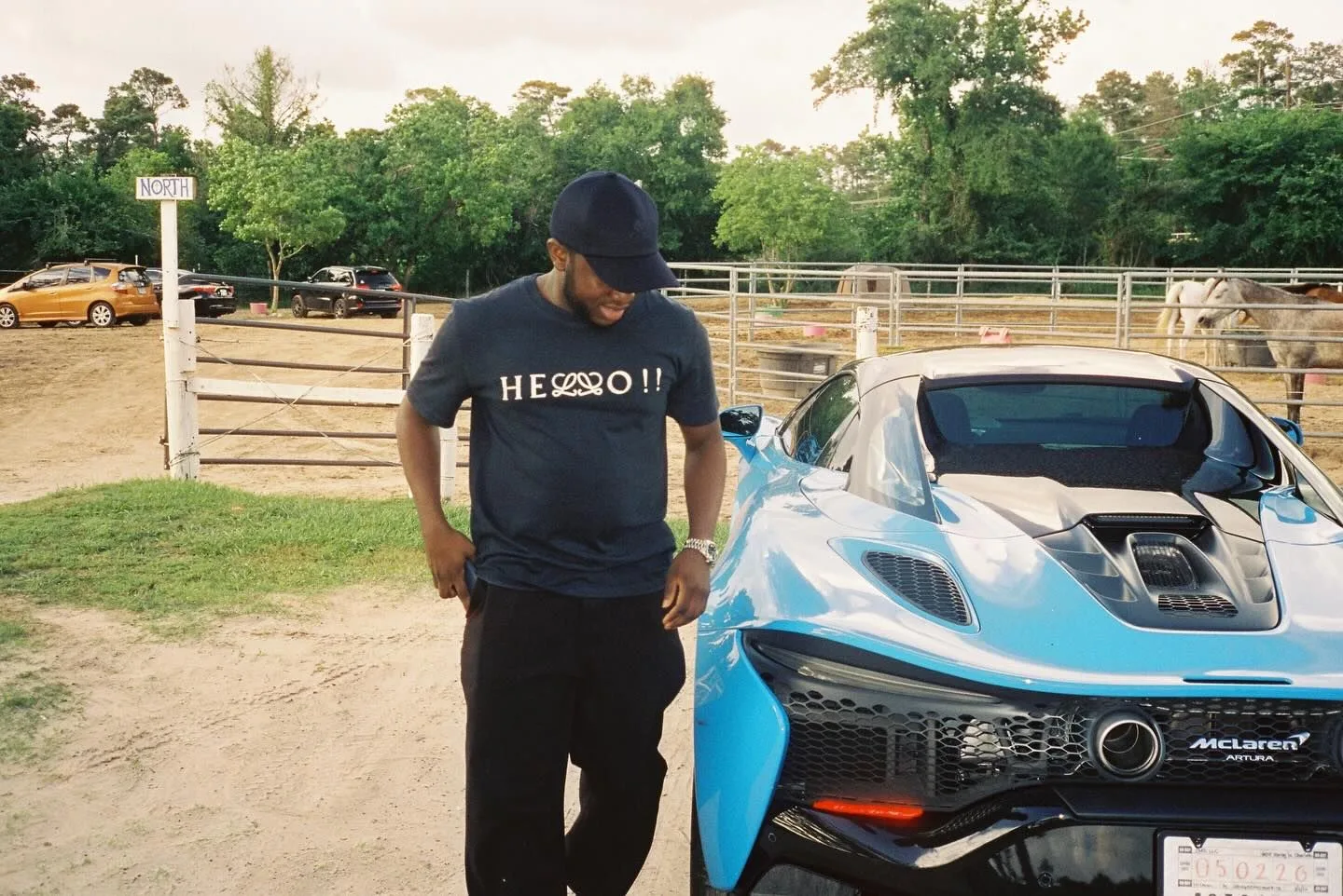 Ahmad Yari beside a car at the stables